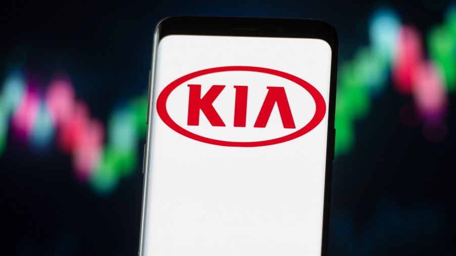 The Kia logo displayed against neon lights