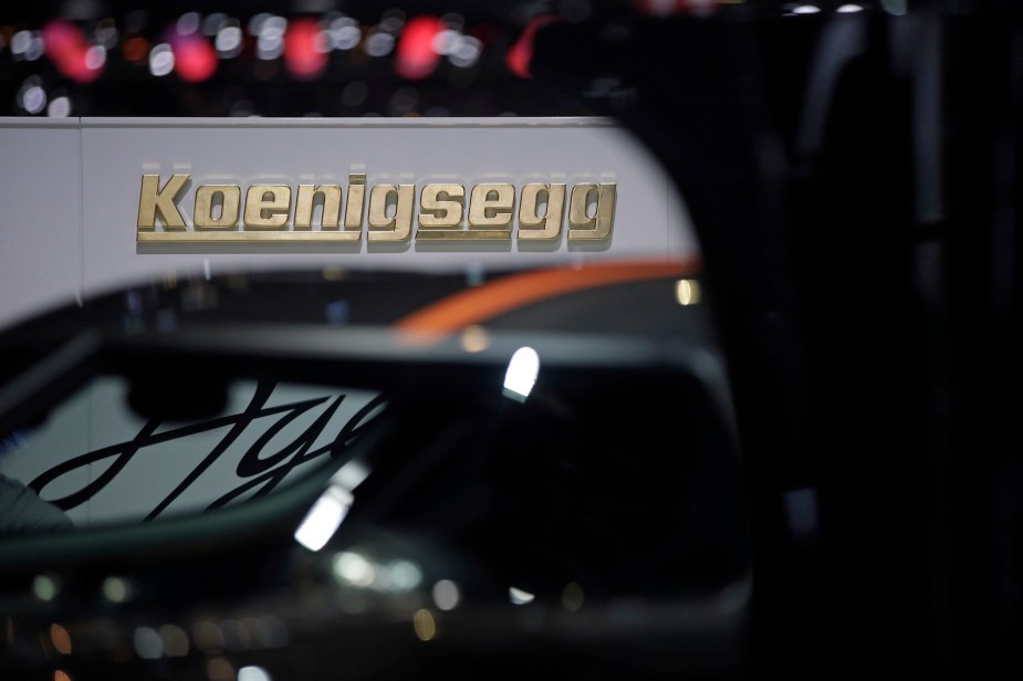 A Koenigsegg logo sits on a wall beyond the automaker's Agera RS hypercar at the 85th Geneva International Motor Show in Geneva, Switzerland, on Wednesday, March 4, 2015