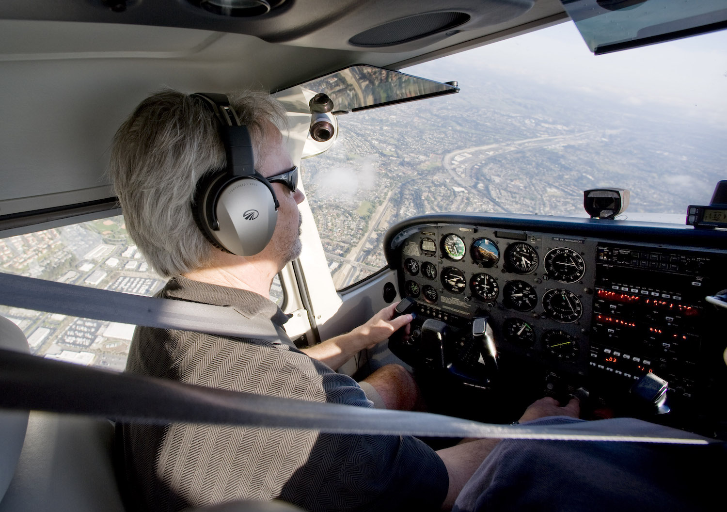 A man flying a Cessna plane over California