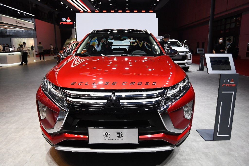 A red Mitsubishi Eclipse Cross car is displayed during the 19th Shanghai International Automobile Industry Exhibition
