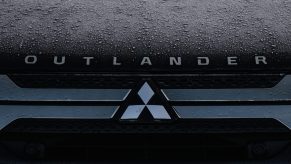 A Mitsubishi logo seen on a parked 2022 Mitsubishi Outlander car in Dublin city center.