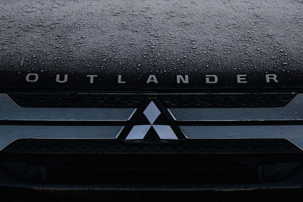 A Mitsubishi logo seen on a parked 2022 Mitsubishi Outlander car in Dublin city center. 