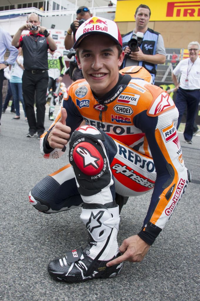 Orange-liveried MotoGP racer Marc Marquez shows off his white-and-black Alpinestars motorcycle track boots