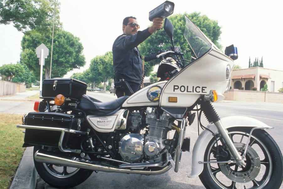 A traffic motorcycle cop pointing a radar gun in Santa Monica, California