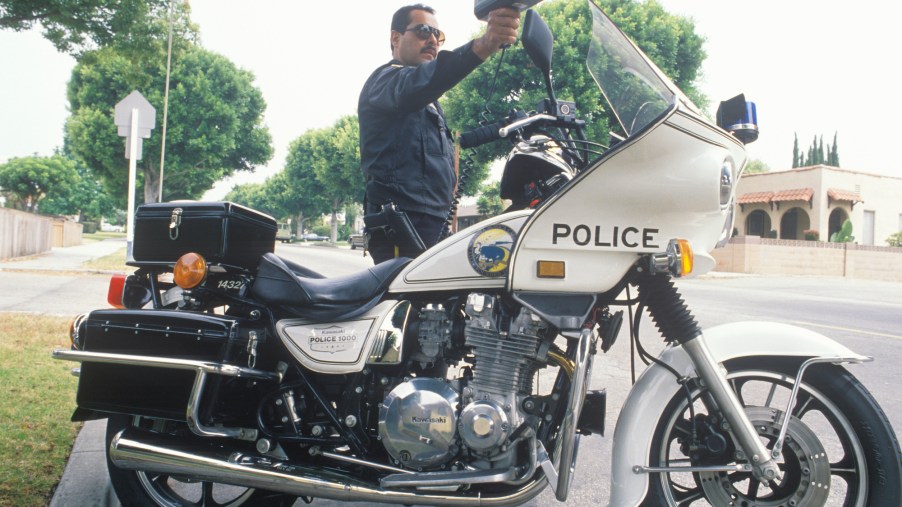 A traffic motorcycle cop pointing a radar gun in Santa Monica, California