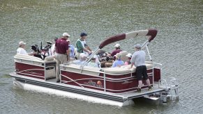 A red pontoon boat is used to ferry players to the 6th green during the first round of the Big Cedar Lodge Legends of Golf presented by Bass Pro Shops at Top of the Rock
