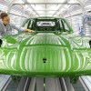 A bright green Porsche Macan on the assembly line