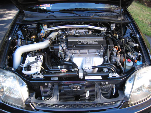 A picture of a non wire-tucked engine bay in a Honda Prelude