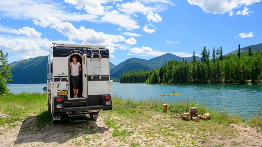 An RV campsite overlooking Hungry Horse Reservoir, South Fork Flathead River, and the Rocky Mountains in northwest Montana on a sunny day