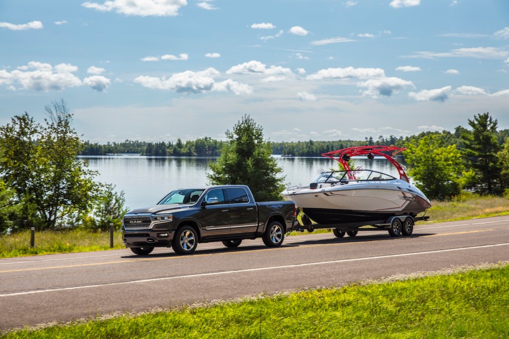 The 2021 Ram 1500 Limited EcoDiesel towing a boat behind it