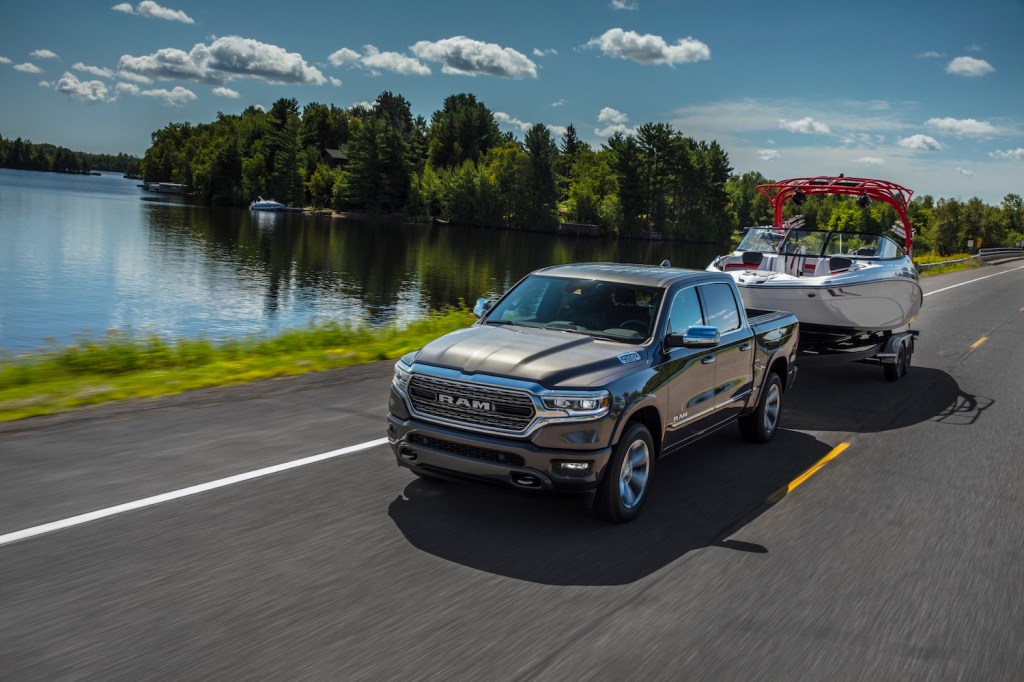 A 2021 Ram 1500 Limited EcoDiesel towing a boat while driving