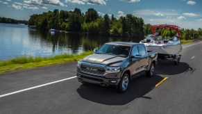 A 2021 Ram 1500 Limited EcoDiesel towing a boat while driving
