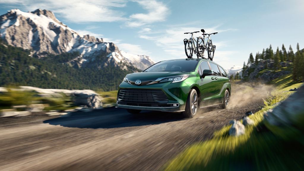The 2021 Toyota Sienna driving on a dirt road