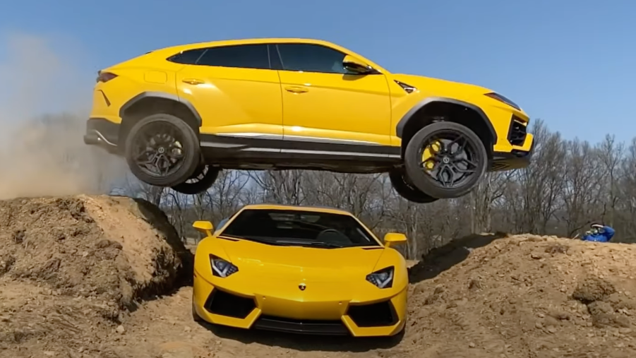 An image of a yellow Lamborghini Urus jumping over an Aventador.
