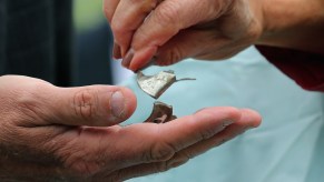 Rep. Jan Schakowsky (D-IL) and Rep. Frank Pallone (D-NJ) hold pieces of metal shrapnel from a defective Takata airbag during a news conference outside the U.S. Capitol on June 2, 2015, in Washington, D.C.