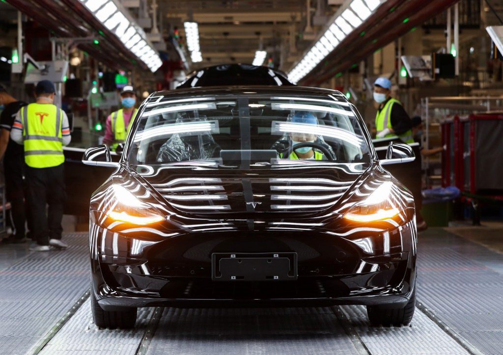 A Tesla Model 3 sits on the assembly line