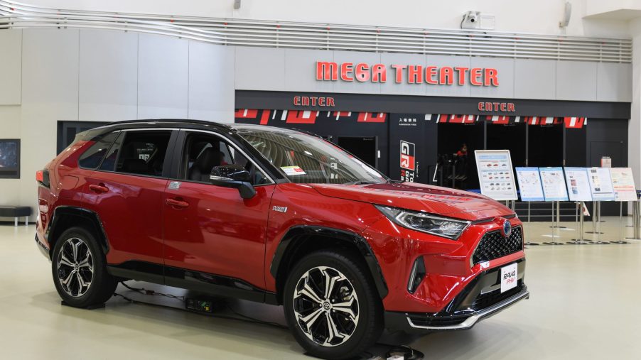 A red Toyota Motor Corp. RAV4 plug-in hybrid sports utility vehicle (SUV) stands on display at the Toyota Mega Web showroom in Tokyo, Japan