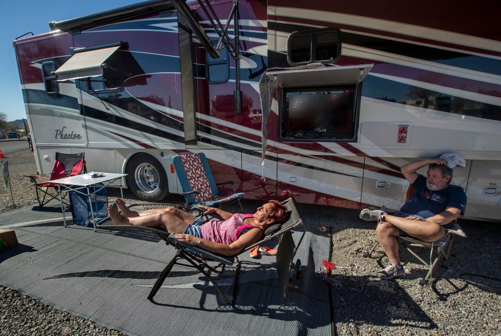 Janna Wilson, 64, and her husband John, 66, sunbathe next to their 40 foot long motorhome located at Quail Run RV Park in Quartzsite, Arizona. They have been full time RVers since June of 2020.