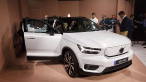 Members of the media view the white Volvo XC40 Recharge electric sports utility vehicle (SUV) during an unveiling event in Los Angeles, California, U.S.