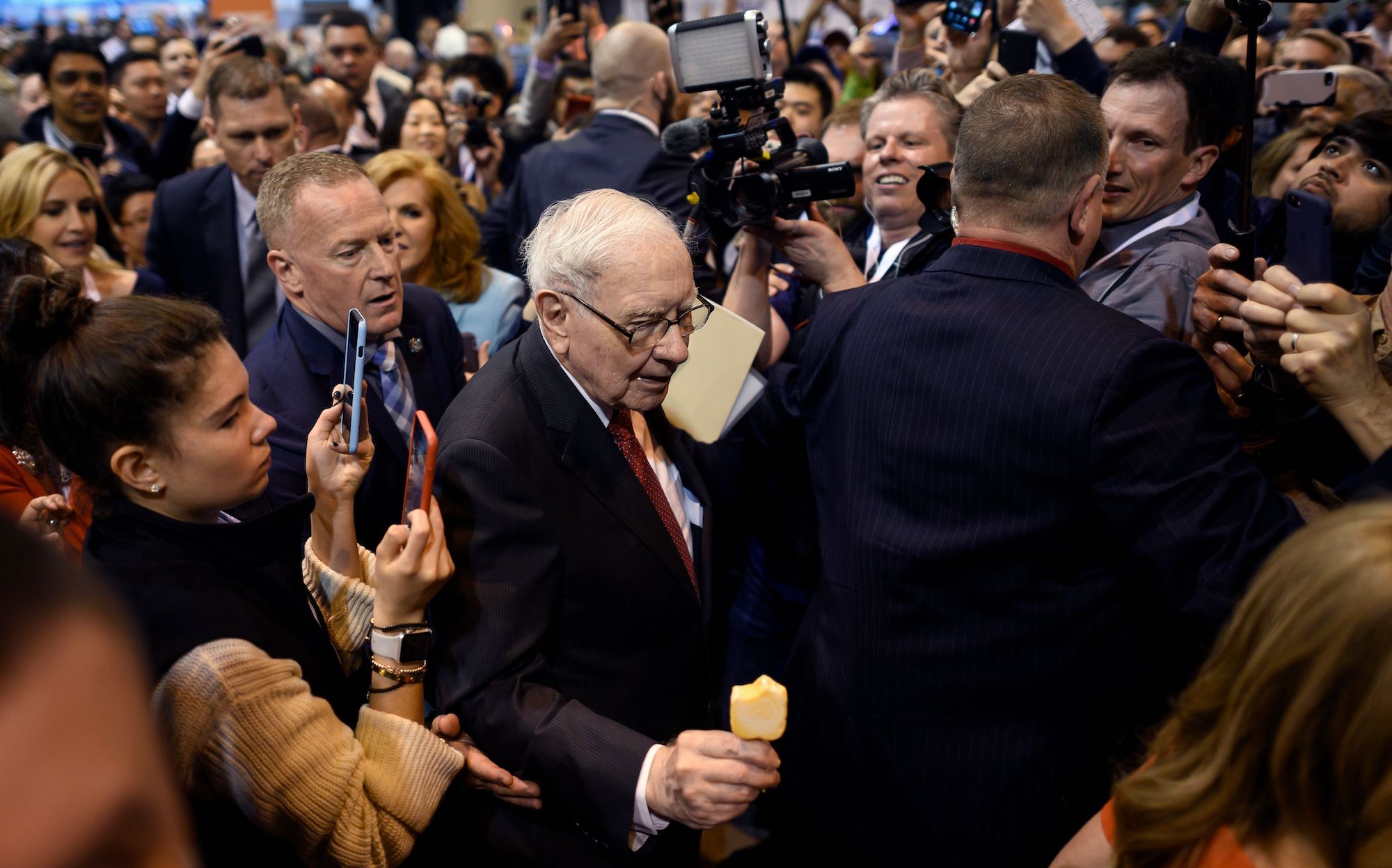 Warren Buffett (center), CEO of Berkshire Hathaway, is surrounded by press and fans as he arrives at the 2019 annual shareholders meeting in Omaha, Nebraska, on May 4, 2019