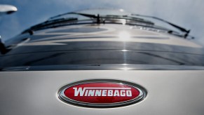 A red Winnebago Industries Inc. logo appears on the front of a 2012 Journey RV at Winnebago Motor Homes in Rockford, Illinois, U.S., on Wednesday, June 13, 2012