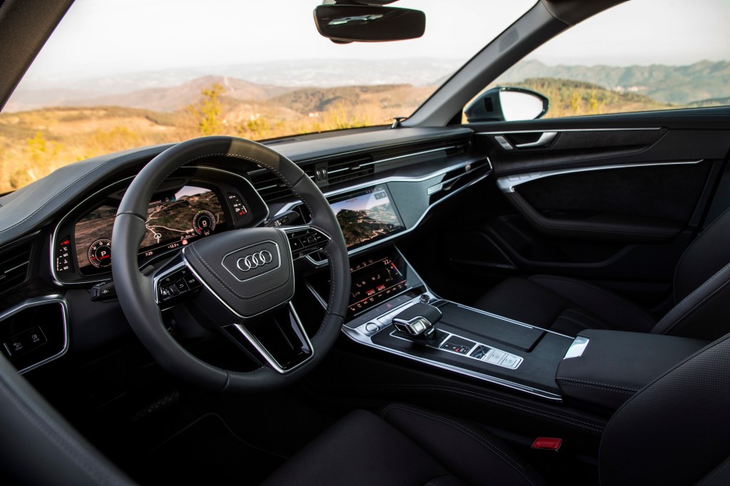 Black leather interior of the 2021 Audi A6 looking in from the driver's side window
