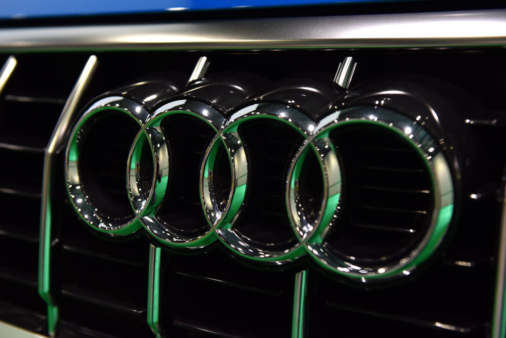 A close up of the four rings of the Audi badge on a front grille