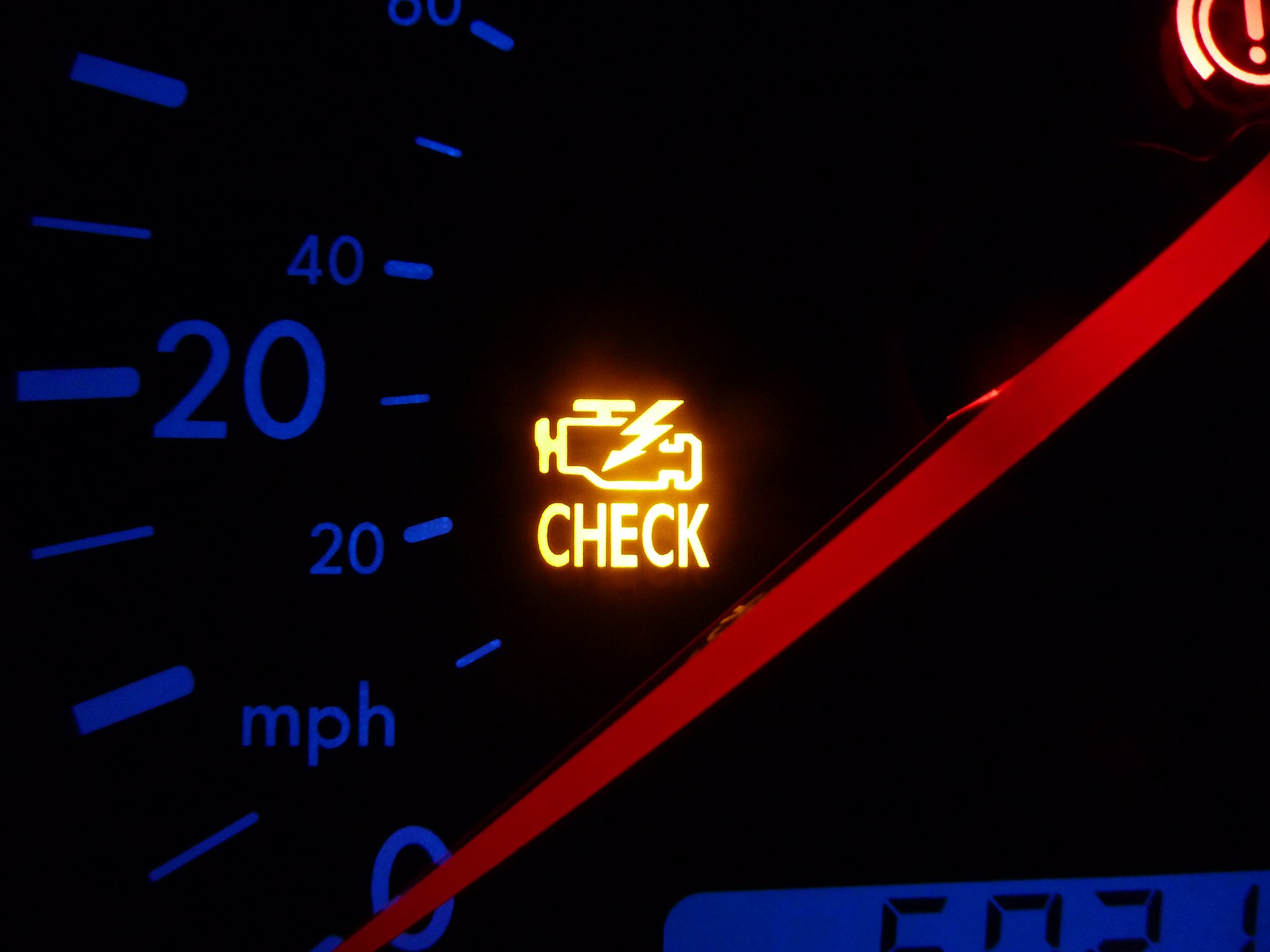 A check engine light on a VW instrument panel