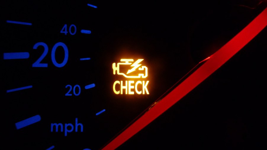 A check engine light on a VW instrument panel