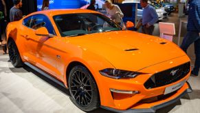 A bright orange Ford Mustang on display