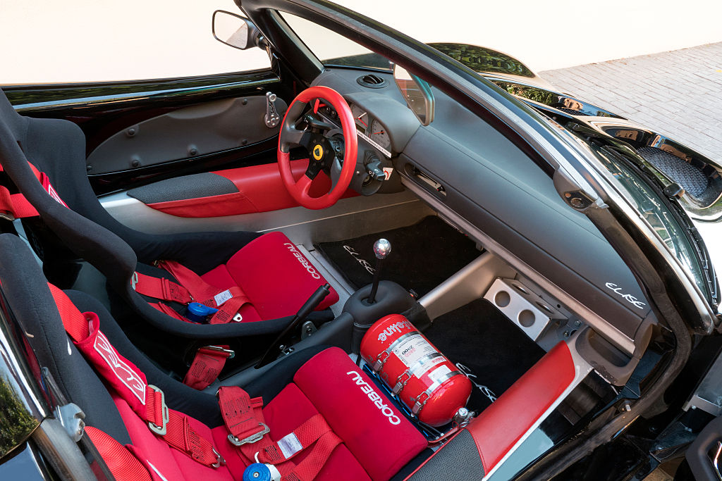 The black and red interior of a Lotus Elise