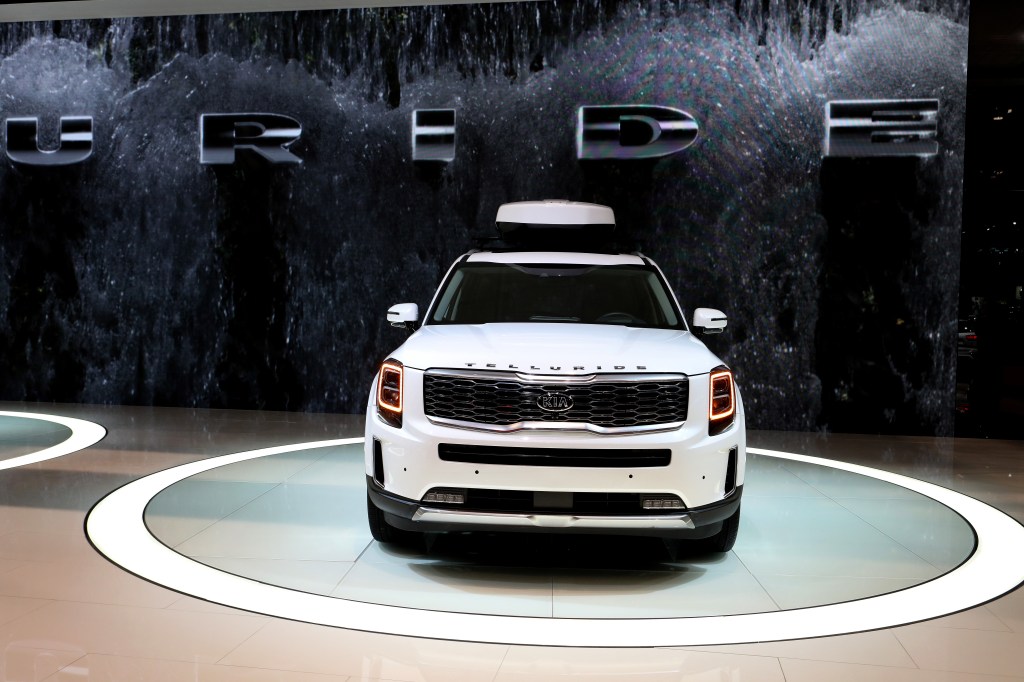 The front end of a white kia telluride on display