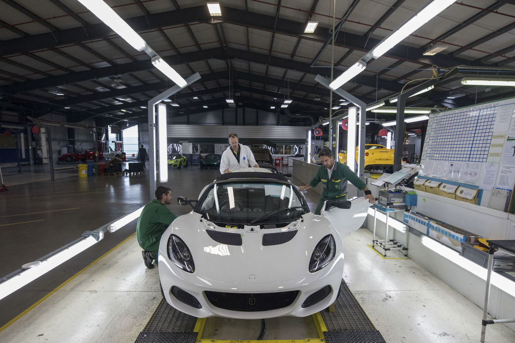 A white Lotus elise on the assembly line