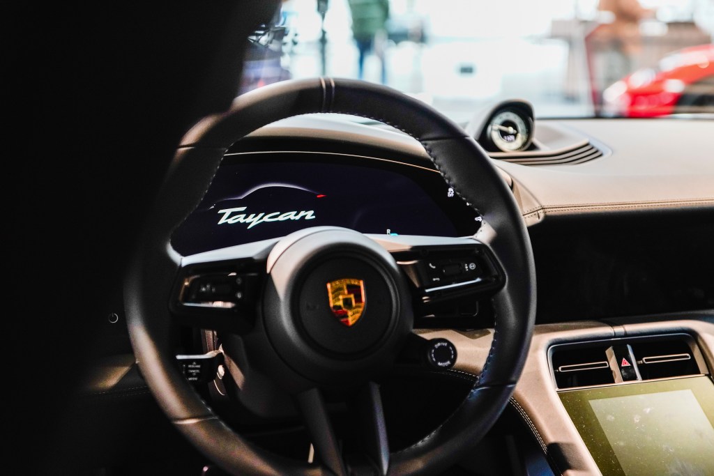The steering wheel and dashboard for the Porsche Taycan interior