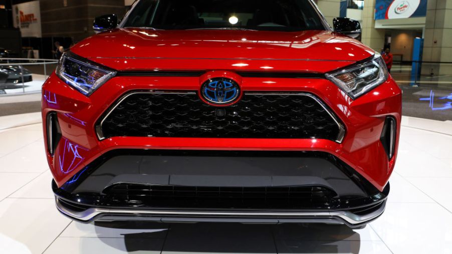 The front end of a red toyota rav4