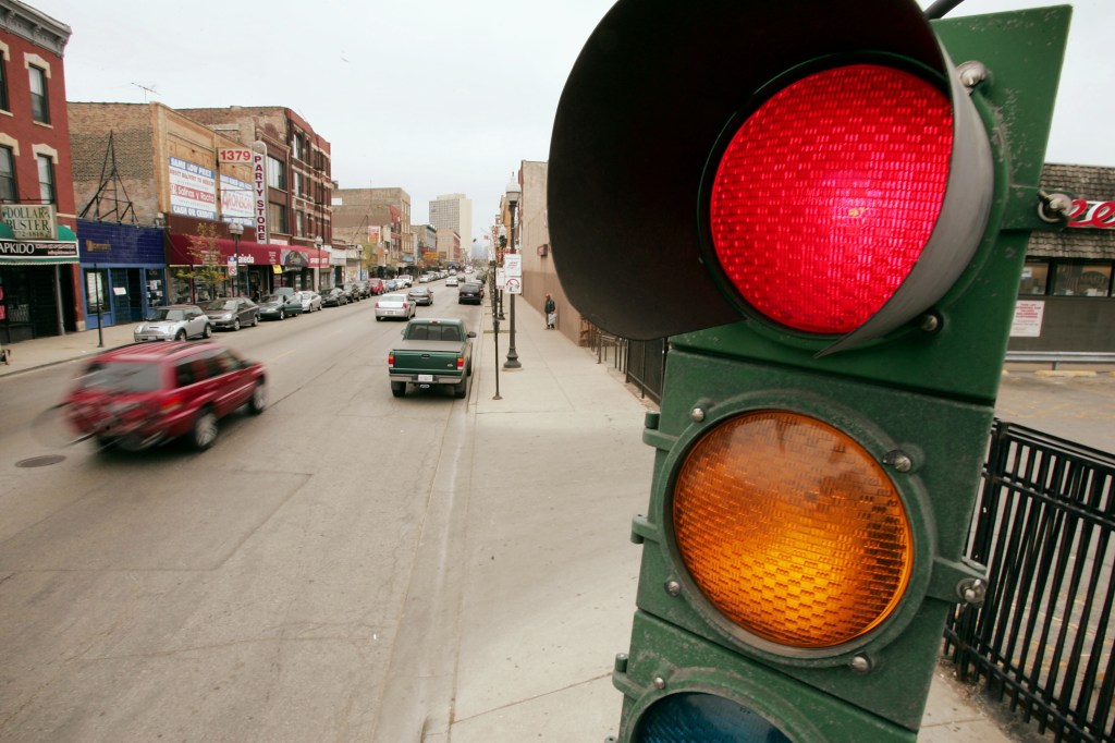 A picture of a traffic light that controls the flow of vehicles and pedestrians.
