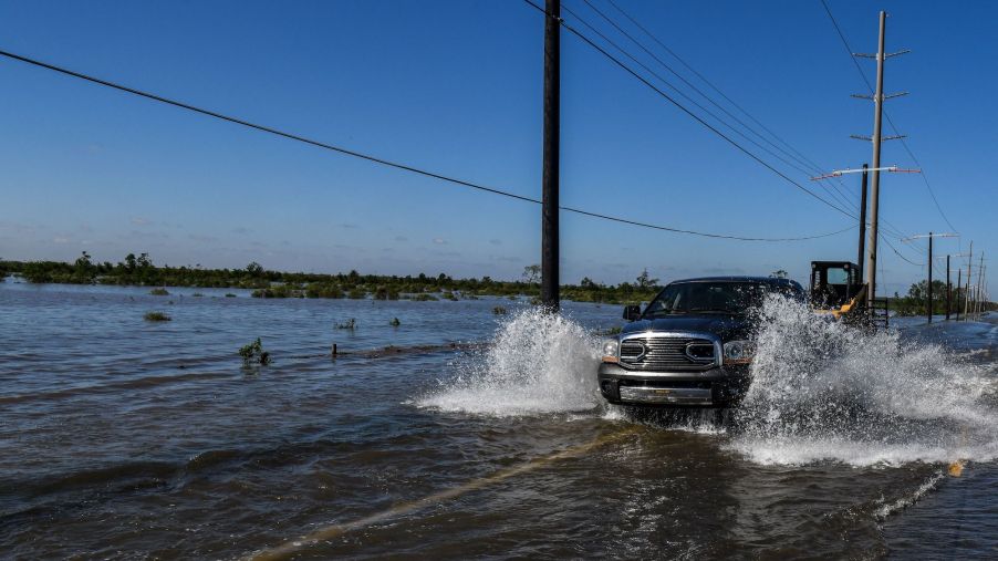 Cars drive through flood water after Hurricane Delta passed through the area on October 10, 2020, near Lake Charles, Louisiana