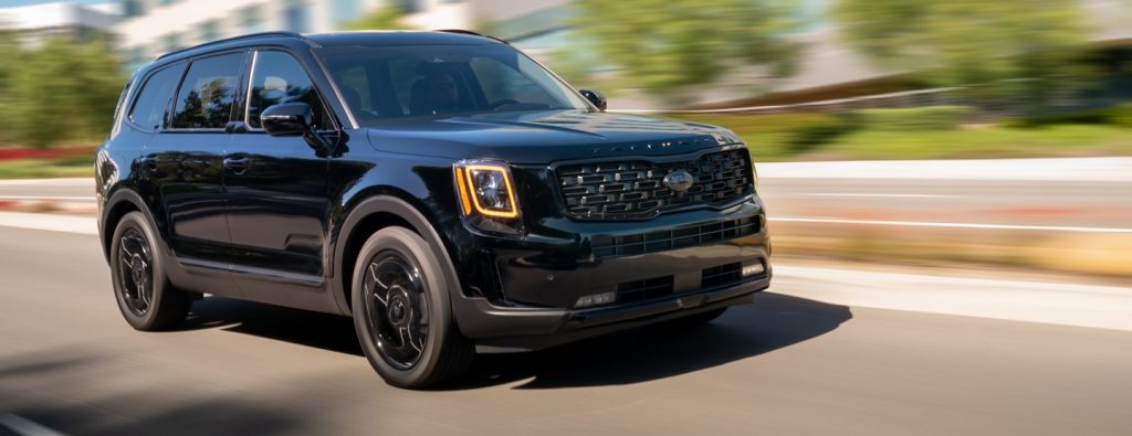 2021 Kia Telluride Nightfall Edition midsize SUV driving on a road at speed