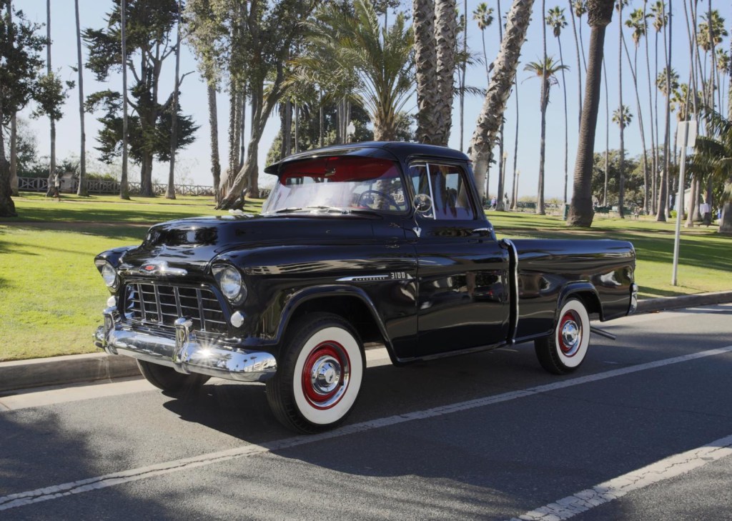 profile of a black 1956 Chevy pickup truck