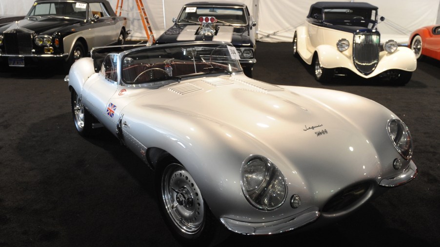 A silver 1957 Jaguar XKSS 3.8-liter replica, valued at $225,000, sits among vintage and classic cars on display