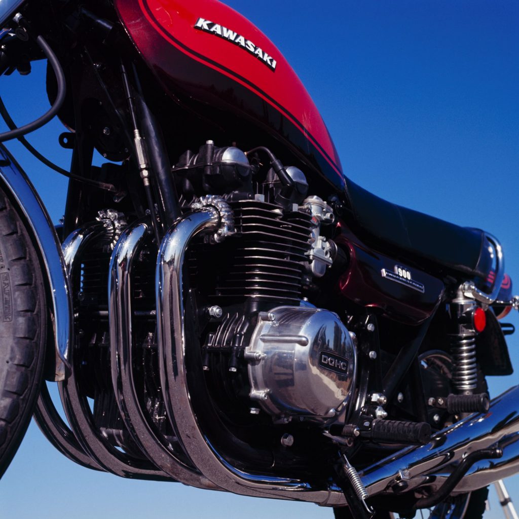A close-up of an orange-and-brown 1973 Kawasaki Z1 900's 903cc inline-four engine