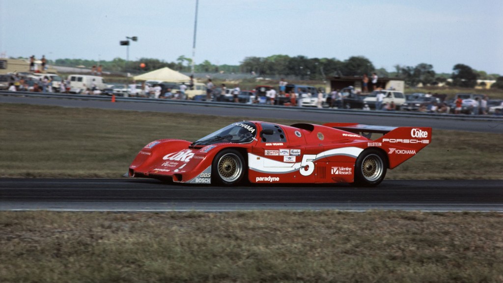 A red-and-white-Coca-Cola-liveried 1986 Porsche 962 at the 24 Hours of Daytona