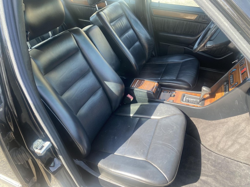The black-leather seats and wood-trimmed center console and dashboard of a 1995 Mercedes-Benz E320