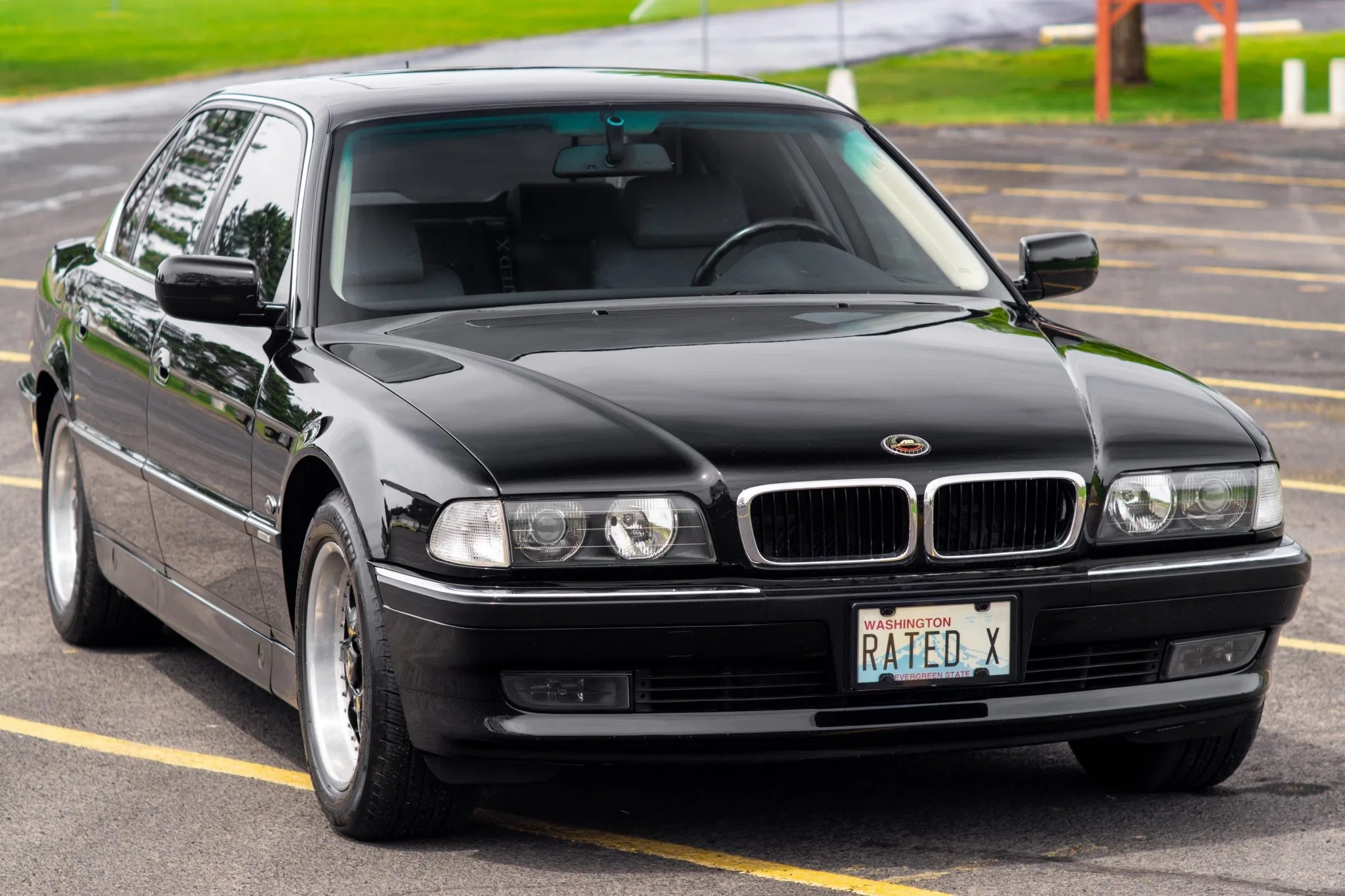 A black 1998 BMW 740iL in a parking lot