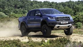 Ford Ranger Raptor jumping on a scenic sandy off-road trail