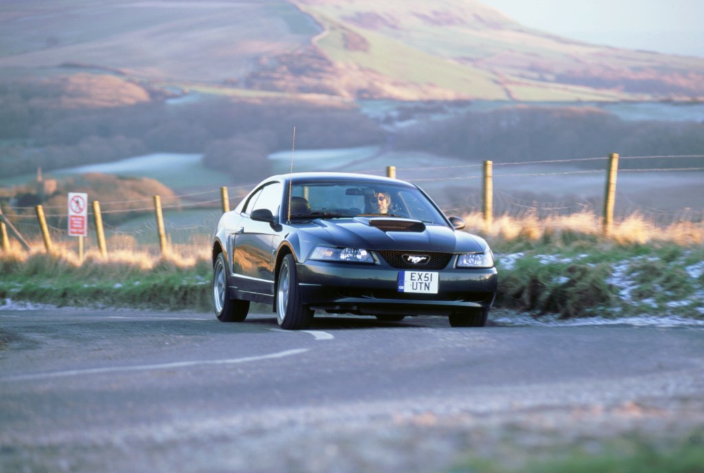 2002 Ford Mustang Bullitt cornering on a country road.