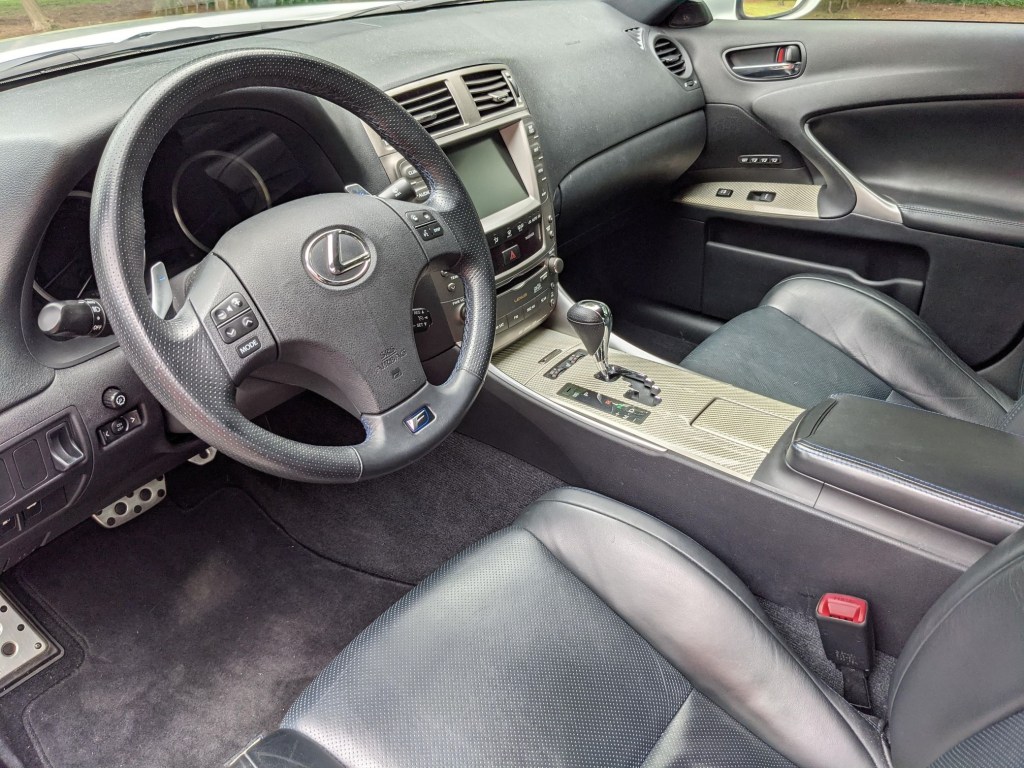 The blue-and-black-leather front seats and gray dashboard of a 2008 Lexus IS F