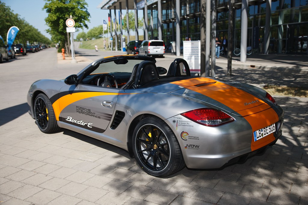 A silver 2011 Porsche Boxster E EV coupe on display outdoors