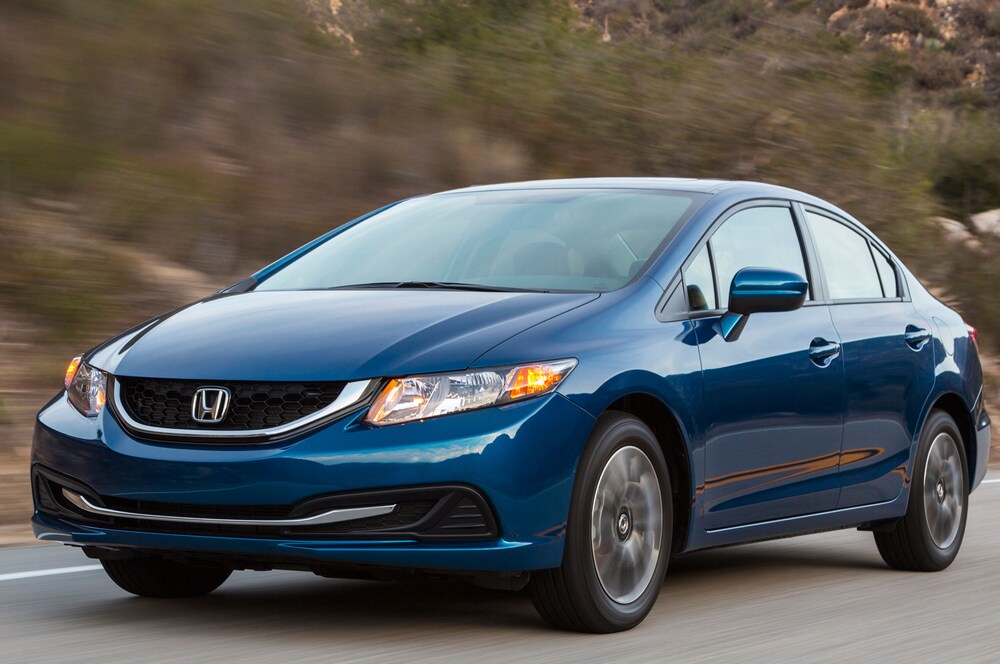 A blue 2015 Honda Civic, Consumer Reports pick for a great city car, rolls up a canyon road