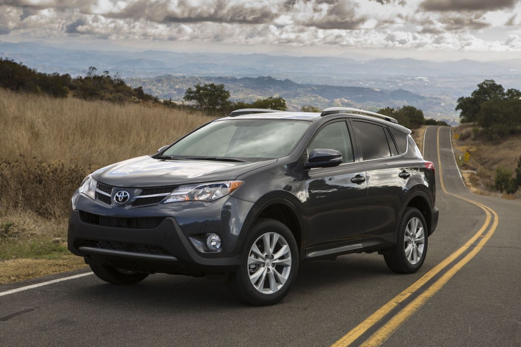 A grey 2015 Toyota RAV4 parked in the street, the RAV4 is among the best affordable used SUVs for teens under $20,000